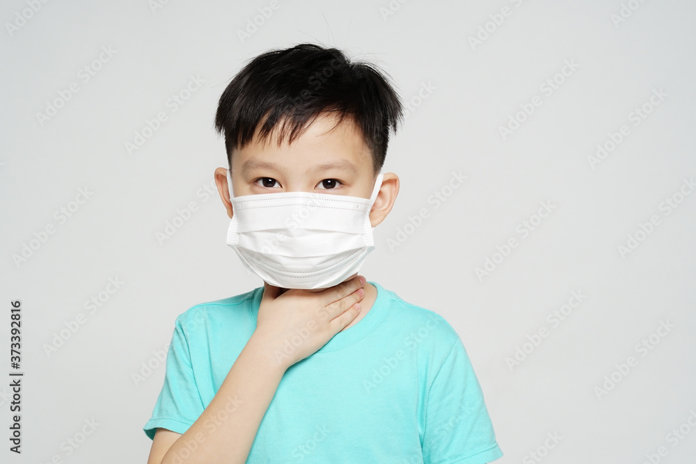 young boy with face mask posing sore throat 