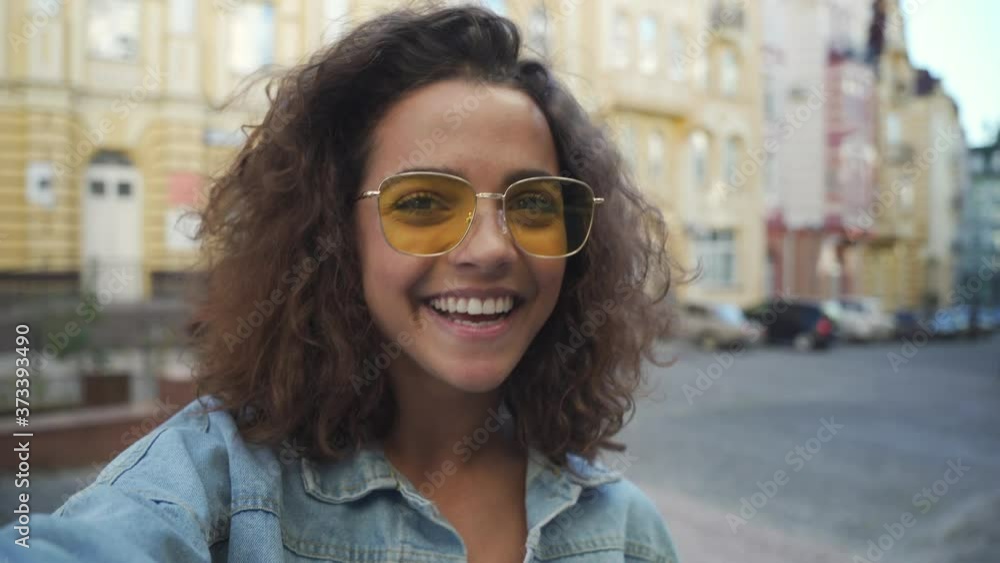Happy hispanic girl recording vlog by mobile phone outdoors. Happy hispanic girl recording vlog by mobile phone outdoors.