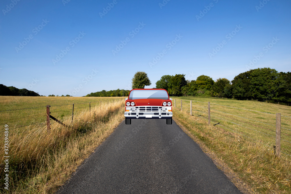 Car travelling down a single lane country road through countryside and farmland