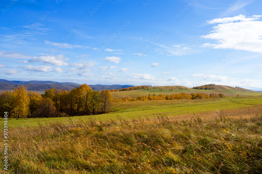 Landscape panorama of a hilly area with autumn colors and blue sky. Landscape panorama of a hilly area with autumn colors and blue sky.