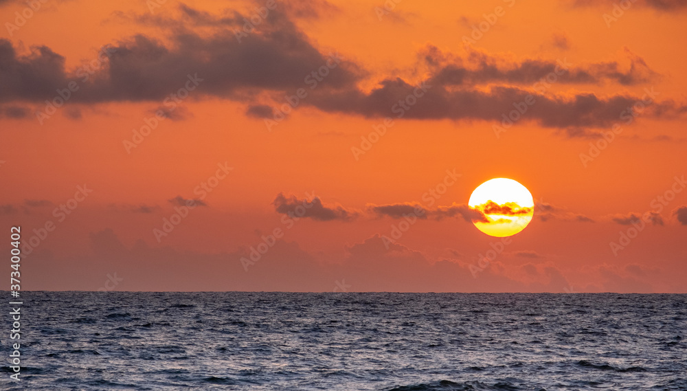 Yellow sun setting over the Indian Ocean in western Sri Lanka