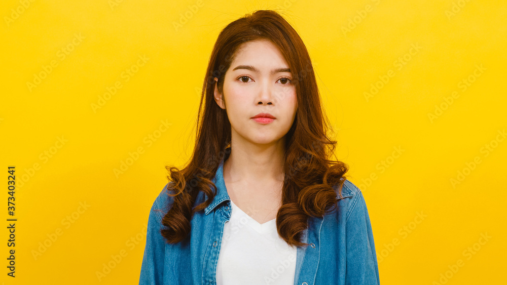 Smiling adorable Asian female with positive expression, smiles broadly, dressed in casual clothing and looking at the camera over yellow background. Happy adorable glad woman rejoices success. Smiling adorable Asian female with positive expression, smiles broadly, dressed in casual clothing and looking at the camera over yellow background. Happy adorable glad woman rejoices success.