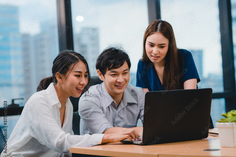 Collaborative process of multicultural businesspeople using laptop presentation and communication meeting brainstorming ideas about project colleagues working plan success strategy in modern office.