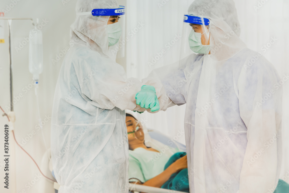 Male and Female Plague Therapist Wearing Plastic Face Shield Protecting Covid-19 greetings in a new way with elbows instead of holding hands, reducing the risk of spreading or coronavirus infection. Male and Female Plague Therapist Wearing Plastic Face Shield Protecting Covid-19 greetings in a new way with elbows instead of holding hands, reducing the risk of spreading or coronavirus infection.