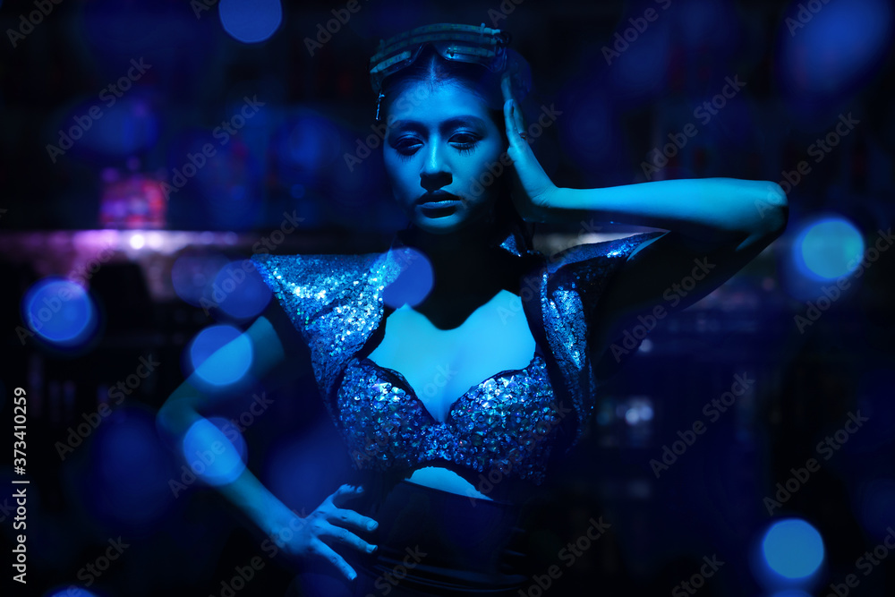 portrait of woman model in fancy dress glowing in blue neon light portrait of woman model in fancy dress glowing in blue neon light