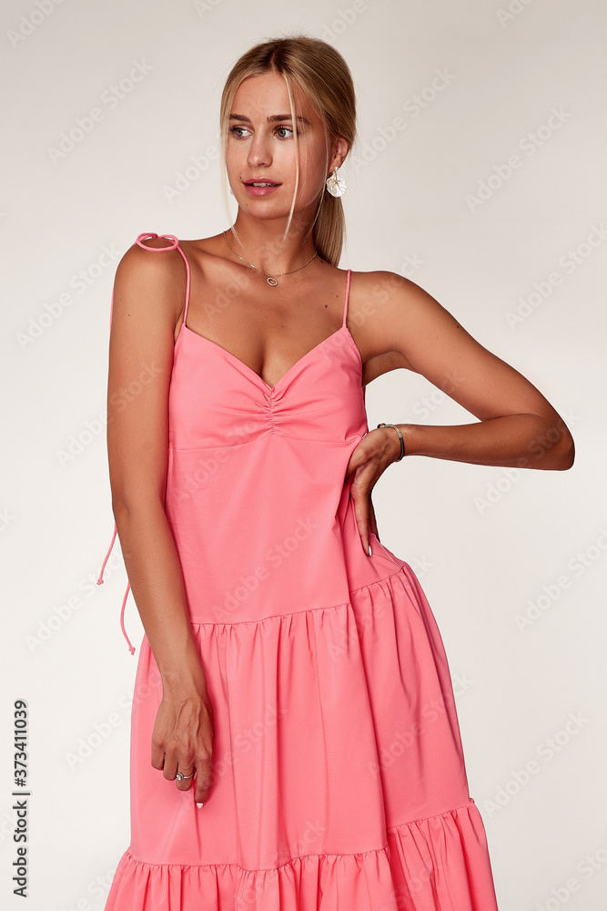 Beautiful woman fashion model makeup brunette hair perfect body shape tanned skin wear clothes summer collection organic long pink silk dress stylish sandals shoes, accessory jewelry earrings date.