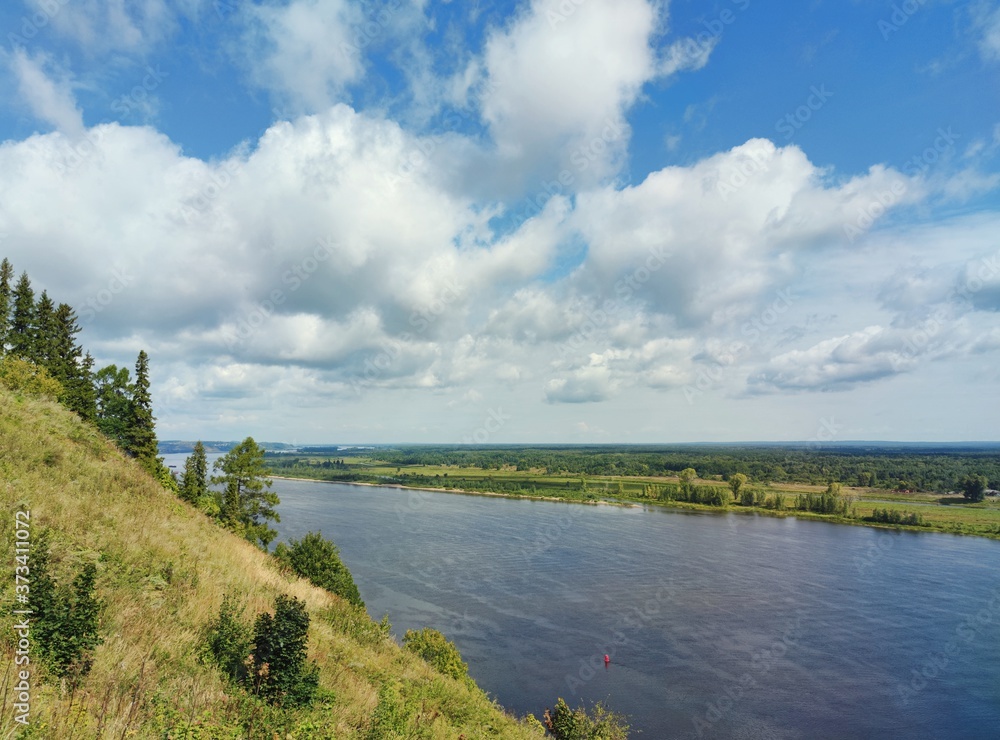 blue sky with clouds over green river banks blue sky with clouds over green river banks
