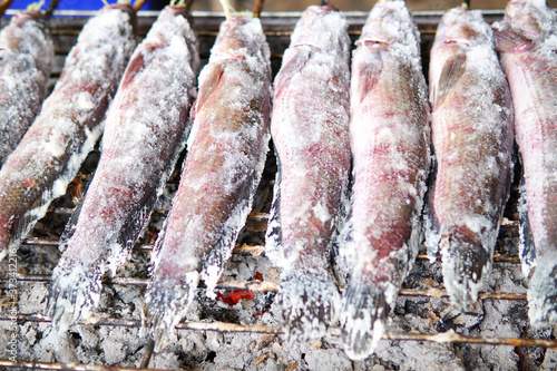Striped snakehead fish grilled with salt. Pomegranate fish with salt and then burned for sales in the market.