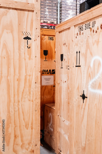 Wooden boxes in the warehouse. Boxes out of wood for packing industrial machinery. Warehousing. Packaging of finished products of the plant. Sale of packaging materials.