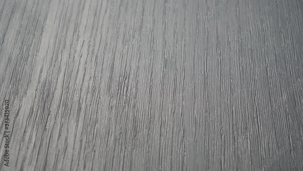 Textured gray painted wooden board close up with cracks Textured gray painted wooden board close up with cracks