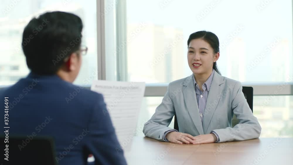 young asian business woman corporate executive being interviewed by HR manager in modern corporation young asian business woman corporate executive being interviewed by HR manager in modern corporation