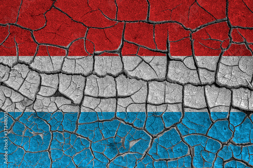 Flag of Luxembourg  Netherlands on a cracked wall  dry ground