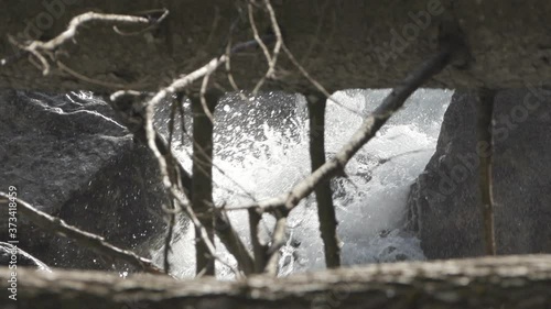 Zoom in to closed frame of how the water comes out between rocks, in the Venosc river, French Alps. Pro Res photo