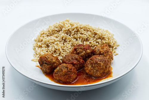 Meatballs with basmati rice on white dish isolated on white bckground