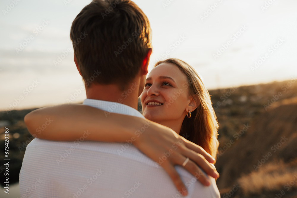 Close up portrait of happy smiling girl, embracing her boyfriend.