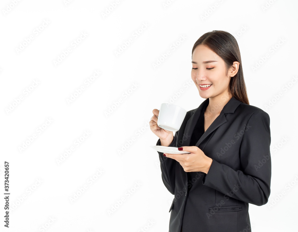 Young Asian smiling businesswoman in suit drinking coffee isolated on white background. Young Asian smiling businesswoman in suit drinking coffee isolated on white background.