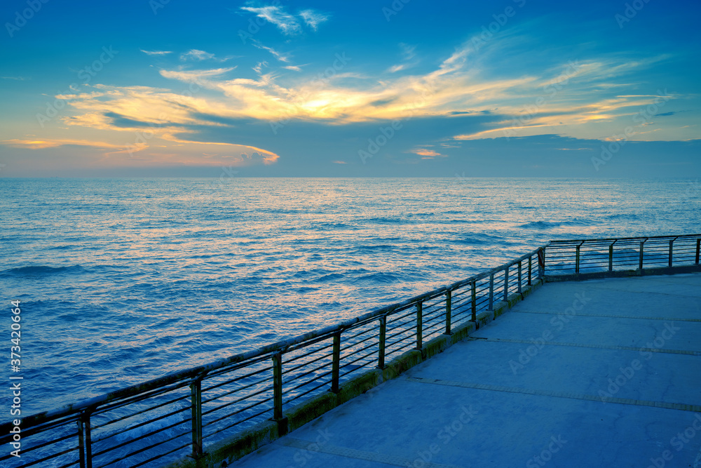 Fototapeta premium Seascape during sunset. The embankment on the beach