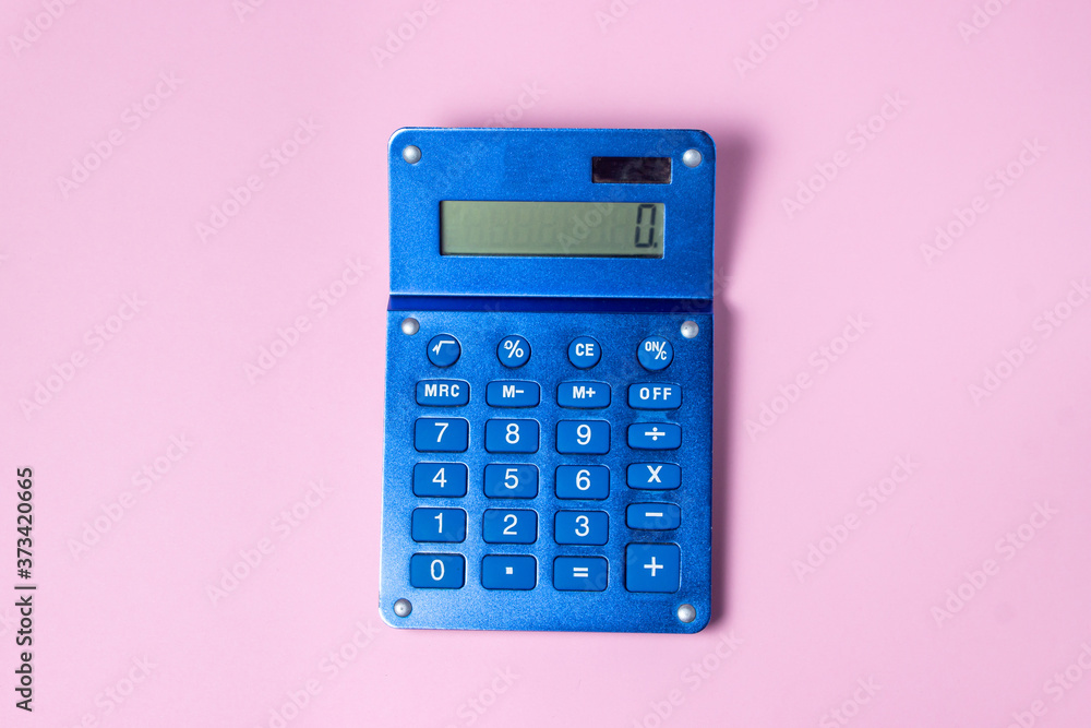 Blue calculator on a pink background. There is a place for an inscription and a logo Blue calculator on a pink background. There is a place for an inscription and a logo