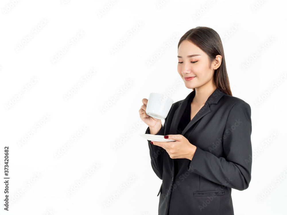 Young Asian smiling businesswoman in suit drinking coffee isolated on white background. Young Asian smiling businesswoman in suit drinking coffee isolated on white background.
