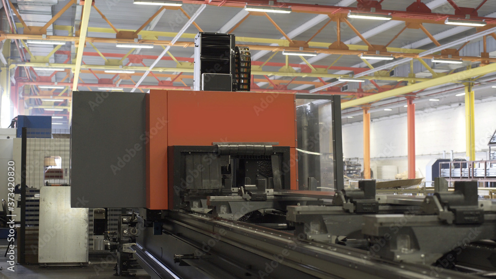 Drilling aluminium profile at workshop. Modern tool in heavy industry. High precision manufacture of aluminium parts. Automation of process indoors. Automatic work for ironwork. Robotic computer cnc Drilling aluminium profile at workshop. Modern tool in heavy industry. High precision manufacture of aluminium parts. Automation of process indoors. Automatic work for ironwork. Robotic computer cnc
