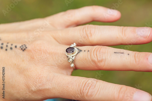 outdoor closeup of female hand with beautiful elegant ring