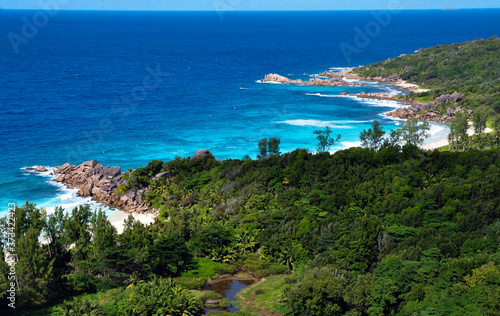 Fototapeta Naklejka Na Ścianę i Meble -  Elevated view of the La Digue Island coastline withe the bay in front of Petite Anse. Seychelles