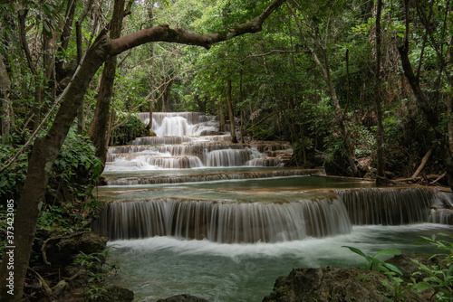 Huay Khamin waterfall with 7 levels located in Kanchanaburi in the midst of nature with green trees. Cold flowing water © kamonrat