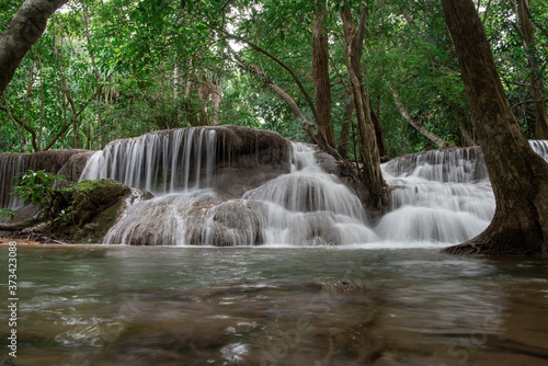 Huay Khamin waterfall with 7 levels located in Kanchanaburi in the midst of nature with green trees. Cold flowing water