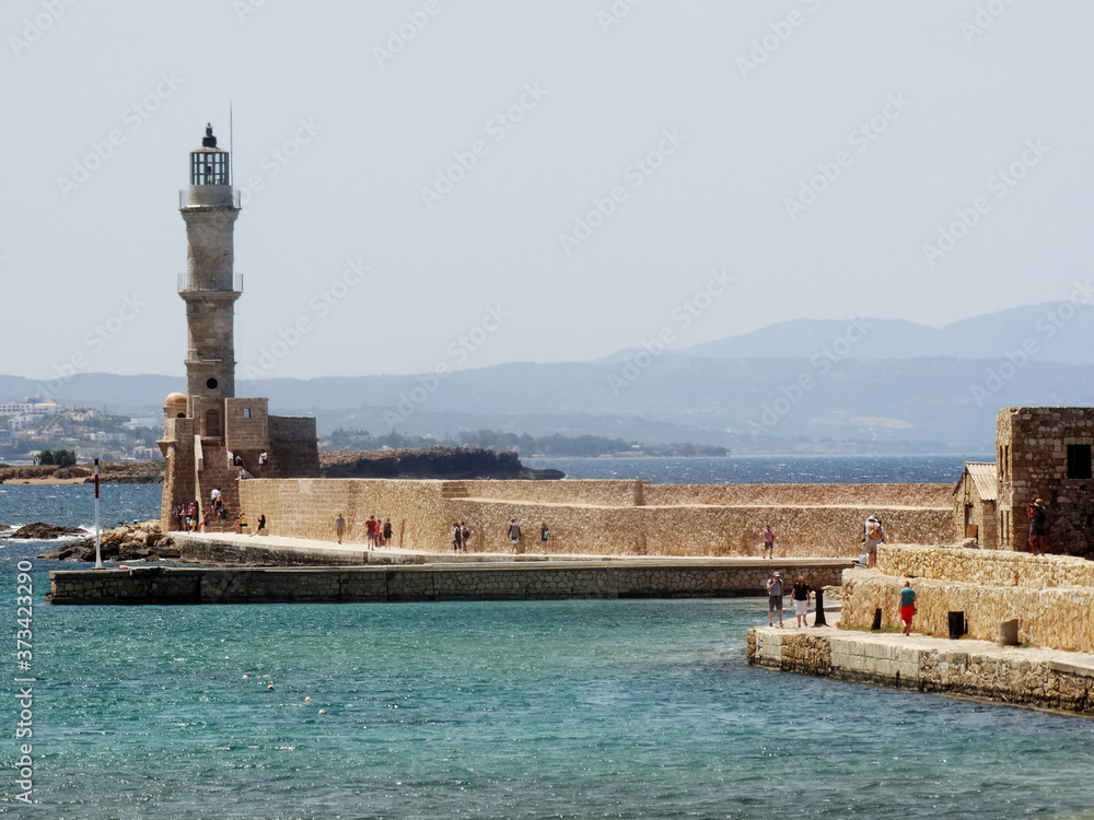 Tourists visit the lighthouse in Chania central in Crete, Greece. The original Venetian lighthouse was built around the late 16th century to protect the harbour.