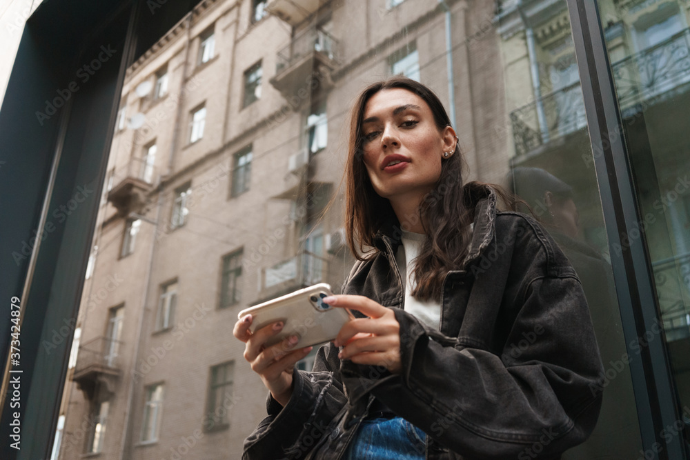 Concentrated pretty young woman walking outdoors Concentrated pretty young woman walking outdoors