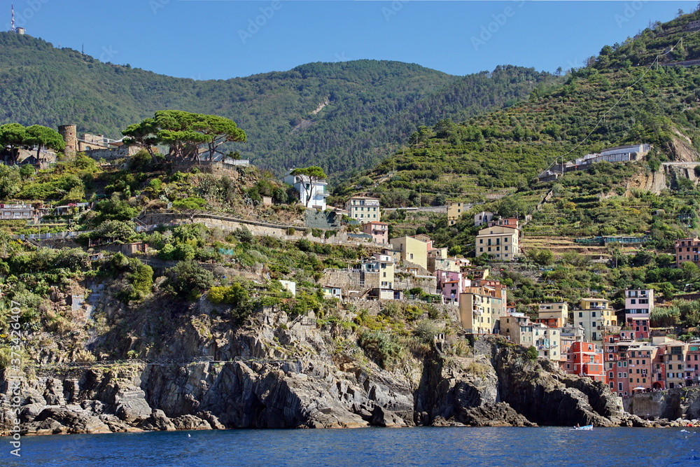 Riomaggiore is an ancient village with colorful houses and a small port, one of the Cique Terre sequence of hill cities on the Mediterranean sea coast in Liguria, Italy