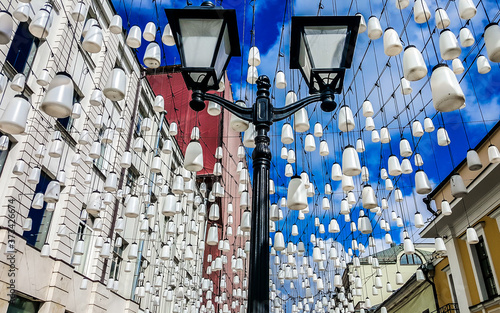 Stoleshnikov lane (Stoleshnikov  Pereulok) decorated with lanterns. Moscow, Russia. photo