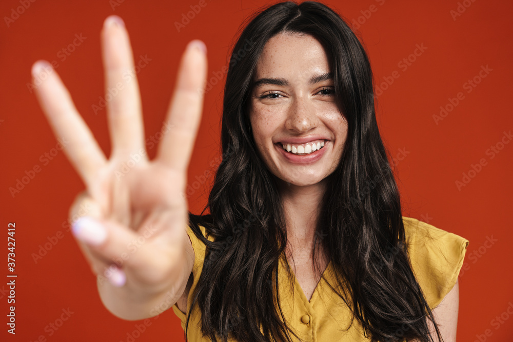 Image of caucasian smiling woman showing three finger at camera Image of caucasian smiling woman showing three finger at camera