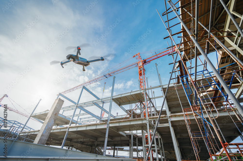 Drone over construction site. video surveillance or industrial inspection.