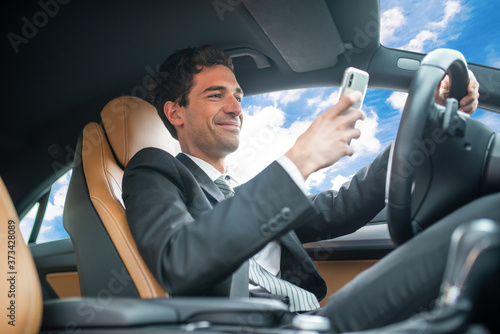 Man using his mobile phone while driving, dangerous behaviour concept © Minerva Studio