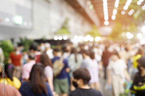 Wallpaper Mural abstract blur background of people Wearing a mask while walking in festival fair shop selling plants vegetable and tree to decorate house and garden. Torontodigital.ca