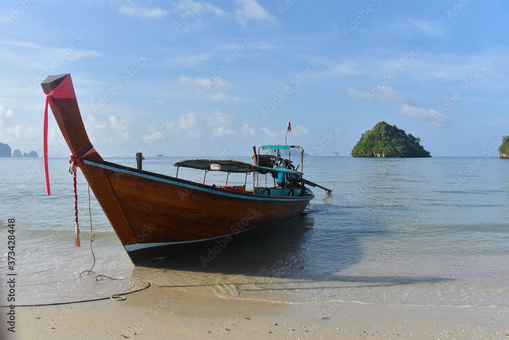 A traditional Thai long tail boat moored on the beaches of the islands of Krabi and the Andaman Sea famous tourist destination in southern Thailand. A traditional Thai long tail boat moored on the beaches of the islands of Krabi and the Andaman Sea famous tourist destination in southern Thailand.
