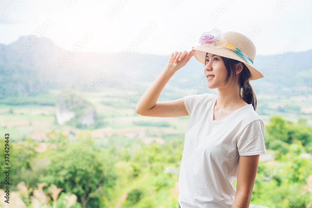 Asian attractive young woman traveler tourist hiking wearing hat standing silhouette looking at mountain nature landscape view scenery, hot summer wearing hat feeling peaceful joyful happy harmony