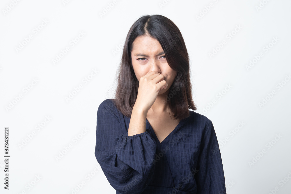 Young Asian woman holding her nose because of a bad smell. Young Asian woman holding her nose because of a bad smell.