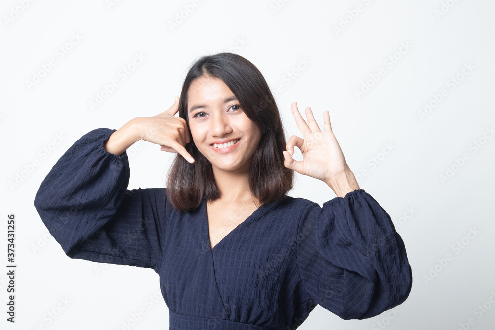 Young Asian woman show with phone gesture and OK sign. Young Asian woman show with phone gesture and OK sign.