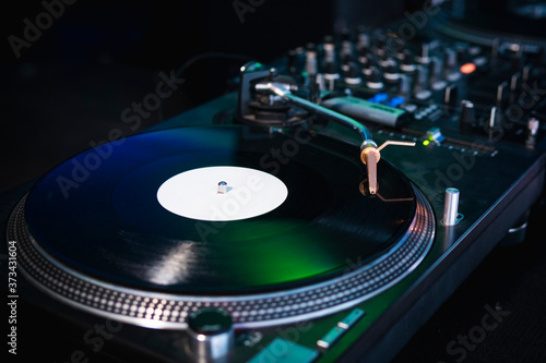 Close-up of modern turntable vinyl record player with music plate. Needle on a vinyl record. Concept of sound technology audio equipment photo