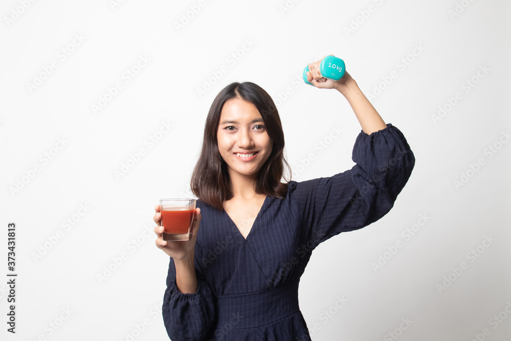 Healthy Asian woman with dumbbell and tomato juice. Healthy Asian woman with dumbbell and tomato juice.
