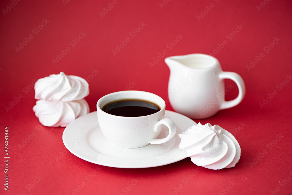 cup of black coffee with marshmallows on a red background cup of black coffee with marshmallows on a red background