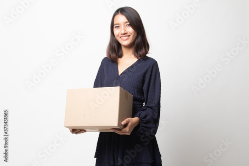 Delivery, relocation and unpacking.  young asian woman holding cardboard box. © halfbottle