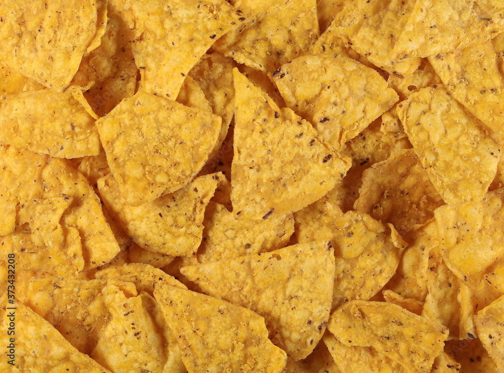 Corn tortilla chips pile, party snacks background and texture Corn tortilla chips pile, party snacks background and texture
