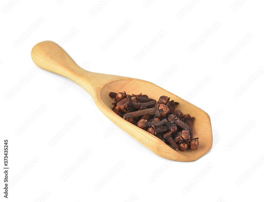 dried cloves in the wooden spoon, isolated on white background dried cloves in the wooden spoon, isolated on white background