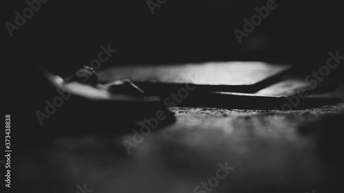 Female hands reach for an object on the floor. A person tries to reach an object lying on the floor in a room.