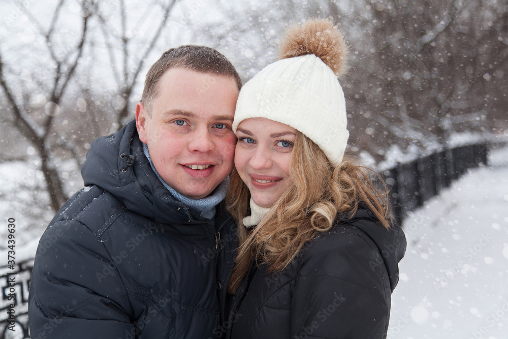 Young couple hugging in winter park