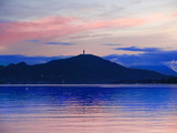 Summer night mountain landscape with Pyramidenkogel on Lake Woerther, Carinthia, Austria. Beautiful view of the lakes at sunset in Klagenfurt.