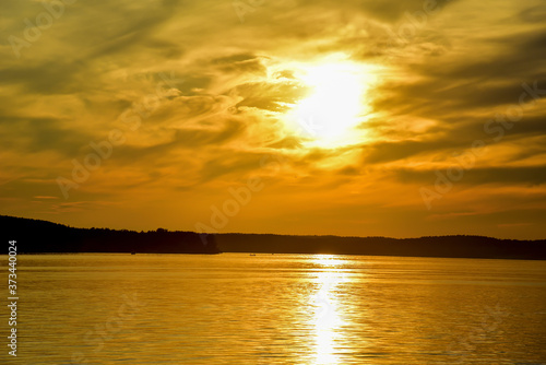 Awesome Sunset with dramatic clouds  in the sky over sea. Landscape Of Lake in sunrise. Sunset sea horizon view. Nature at dusk over the ocean